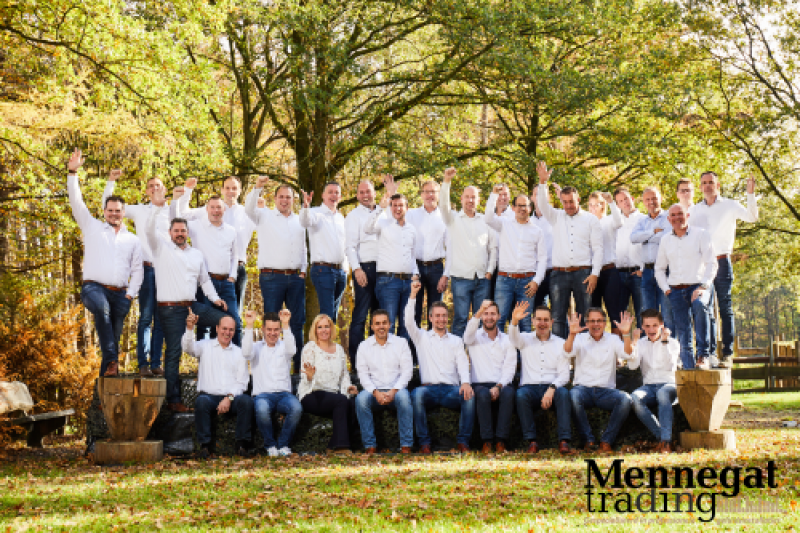 group of people standing/sitting raising their hands posing for a picture in a park